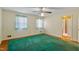 A bedroom featuring hardwood floors with an area rug, two windows with curtains, and a ceiling fan at 7620 Harps Mill Rd, Raleigh, NC 27615