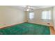 A bedroom featuring hardwood floors with an area rug, two windows with curtains, and a ceiling fan at 7620 Harps Mill Rd, Raleigh, NC 27615