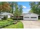 Charming home with a well-manicured lawn, a two-car garage, and mature trees at 7620 Harps Mill Rd, Raleigh, NC 27615