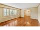 Spacious living room featuring hardwood floors and ample natural light from shuttered windows at 7620 Harps Mill Rd, Raleigh, NC 27615
