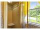 Walk-in shower with glass door, tiled walls, marble bench, and natural light from a window at 7620 Harps Mill Rd, Raleigh, NC 27615