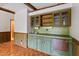A wet bar with wood cabinetry, a sink, and a refrigerator at 7620 Harps Mill Rd, Raleigh, NC 27615