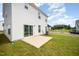 View of backyard with green grass and small patio, sliding door to home at 80 Nailsworth St, Angier, NC 27501