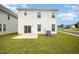 View of backyard with green grass and small patio, white siding home at 80 Nailsworth St, Angier, NC 27501