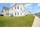 Spacious backyard with green grass and white siding on home at 80 Nailsworth St, Angier, NC 27501