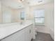 Well-lit bathroom with plank flooring, white cabinetry, and a large mirror at 80 Nailsworth St, Angier, NC 27501