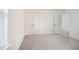 Neutral bedroom with plush carpet, double closet, and view into the hallway at 80 Nailsworth St, Angier, NC 27501