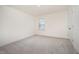 Simple bedroom with neutral carpet, one window, and a closet with traditional doors at 80 Nailsworth St, Angier, NC 27501