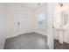 Bright entryway featuring wood-look floors, a powder room, and natural light from a window at 80 Nailsworth St, Angier, NC 27501