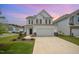 Charming two-story home with blue shutters, attached garage and well-maintained lawn at 80 Nailsworth St, Angier, NC 27501