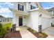 Inviting front entrance featuring a covered porch, well-maintained lawn, and two-car garage at 80 Nailsworth St, Angier, NC 27501