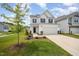 Charming two-story home featuring a two-car garage, manicured lawn, and tasteful landscaping at 80 Nailsworth St, Angier, NC 27501