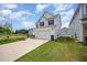 Beautiful two-story home with a two-car garage, lush lawn, and convenient driveway at 80 Nailsworth St, Angier, NC 27501