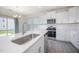 Close-up of the kitchen with stainless steel sink, white cabinets, and a gas range stove at 80 Nailsworth St, Angier, NC 27501