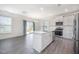 Bright kitchen featuring white cabinets, a center island with a sink, and stainless steel appliances at 80 Nailsworth St, Angier, NC 27501