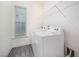 Laundry room equipped with a washer, dryer, and wire rack shelving at 80 Nailsworth St, Angier, NC 27501