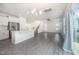 Open-concept living space featuring wood-look floors, a modern chandelier, and stainless steel kitchen appliances at 80 Nailsworth St, Angier, NC 27501