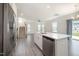 Open-concept living space featuring wood-look floors, a modern chandelier, and stainless steel kitchen appliances at 80 Nailsworth St, Angier, NC 27501