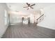 Open concept living area leading to the kitchen, featuring wood-look floors and ample natural light at 80 Nailsworth St, Angier, NC 27501