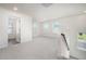 Spacious loft area bathed in natural light from multiple windows, carpeted floor at 80 Nailsworth St, Angier, NC 27501