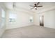 Spacious main bedroom featuring plush carpet, ceiling fan, and abundant natural light from multiple windows at 80 Nailsworth St, Angier, NC 27501