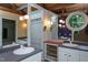 Bathroom with double vanity, ample mirrors, unique lighting, and natural light at 820 Runnymede Rd, Raleigh, NC 27607