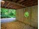 Open basement showing concrete foundation, a circular window and gravel floor at 820 Runnymede Rd Rd, Raleigh, NC 27607