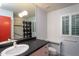 Well-lit bathroom with a spacious vanity and a large mirror at 820 Runnymede Rd Rd, Raleigh, NC 27607