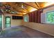 Bedroom with wooden ceiling beams and natural light provided by many windows at 820 Runnymede Rd Rd, Raleigh, NC 27607