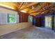 Bedroom features high ceilings with exposed beams, natural light, and a rustic chest of drawers at 820 Runnymede Rd Rd, Raleigh, NC 27607
