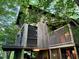 Unique home design featuring wood siding, balconies, and a serene natural setting at 820 Runnymede Rd Rd, Raleigh, NC 27607