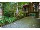 Modern home exterior with gravel driveway, blue railing and plenty of shade at 820 Runnymede Rd Rd, Raleigh, NC 27607