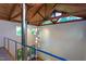 Bright foyer featuring wood beams, a railing, and unique pendant lighting at 820 Runnymede Rd Rd, Raleigh, NC 27607