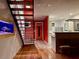 Modern interior with open staircase, bright red wall, and sleek kitchen design at 820 Runnymede Rd Rd, Raleigh, NC 27607
