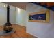 Bright living room with wood floors, fireplace, and a unique fish tank feature at 820 Runnymede Rd Rd, Raleigh, NC 27607