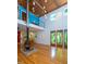 Bright living room with hardwood floors, a modern fireplace, and views of the lush backyard at 820 Runnymede Rd Rd, Raleigh, NC 27607