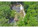 Bird's eye view of the house, featuring the garage, driveway, and surrounding tree coverage at 88 Priscilla Ln, Fuquay Varina, NC 27526
