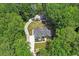 Aerial shot showcases a well-kept home encircled by dense trees and a long driveway at 88 Priscilla Ln, Fuquay Varina, NC 27526