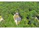 Property overview highlighting a house nestled among dense trees and a driveway at 88 Priscilla Ln, Fuquay Varina, NC 27526