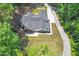 Aerial shot showcasing a modern home with a well-manicured lawn, back porch, and surrounding trees at 88 Priscilla Ln, Fuquay Varina, NC 27526