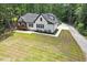 Aerial view of a beautiful home, long driveway, spacious lawn, and lush landscaping at 88 Priscilla Ln, Fuquay Varina, NC 27526