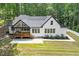 Aerial shot of modern farmhouse with manicured lawn, long driveway, and back porch at 88 Priscilla Ln, Fuquay Varina, NC 27526