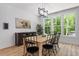 Bright dining room featuring large windows with wooded outdoor views and contemporary light fixture at 88 Priscilla Ln, Fuquay Varina, NC 27526