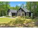 Inviting home with a well-manicured lawn, charming front porch, and lush landscaping at 88 Priscilla Ln, Fuquay Varina, NC 27526