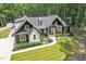 Charming two-story home with black and white exterior, lush landscaping, and a inviting front porch at 88 Priscilla Ln, Fuquay Varina, NC 27526