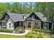 Stunning modern farmhouse with black trim, white siding, well-manicured landscaping, and a welcoming front porch at 88 Priscilla Ln, Fuquay Varina, NC 27526