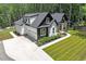 New home with a spacious driveway, well-maintained lawn, and beautifully landscaped front yard at 88 Priscilla Ln, Fuquay Varina, NC 27526