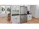 Bright kitchen featuring stainless steel refrigerator and modern white cabinetry with black hardware at 88 Priscilla Ln, Fuquay Varina, NC 27526