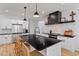 Well-equipped kitchen featuring a large island with seating, white cabinetry, and modern fixtures at 88 Priscilla Ln, Fuquay Varina, NC 27526