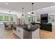Open-concept kitchen with a large island, stainless steel appliances, and a view of the living area at 88 Priscilla Ln, Fuquay Varina, NC 27526